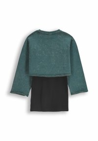 Dwukolorowa bluzka z teksturowanym zielonym górnym materiałem i czarną dolną częścią. Długie rękawy i okrągły dekolt zakończone surowym brzegiem.