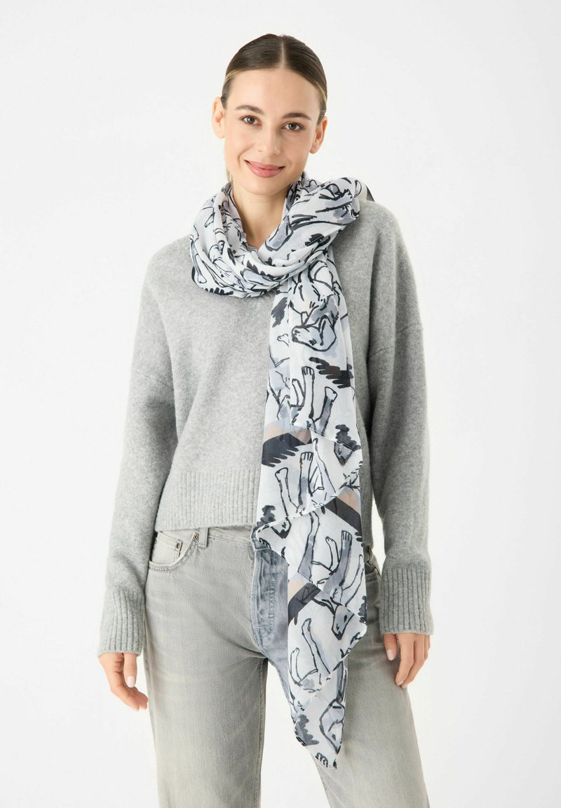 Écharpe légère à motif avec un design gris et blanc et des contours d'animaux. Tissu doux et transparent qui se drape élégamment autour du cou.