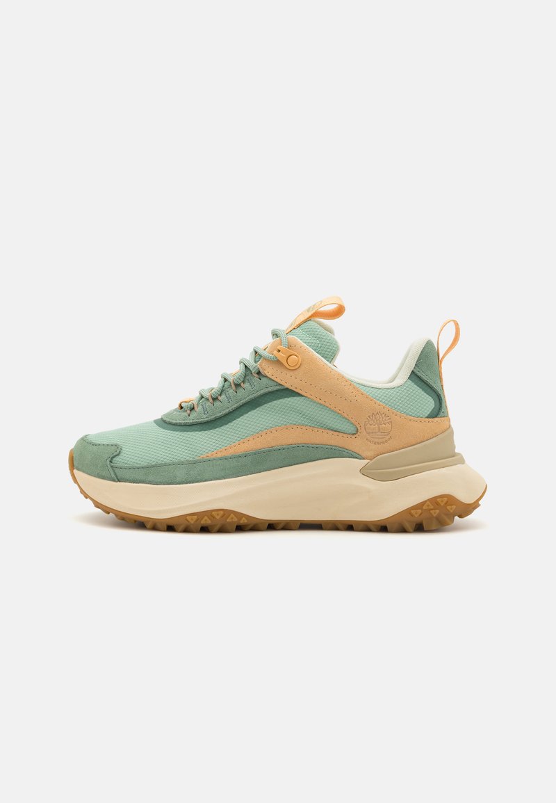 Light green athletic shoe with tan accents, mesh and suede materials, textured surface, and a rugged rubber sole. Features a pull tab.