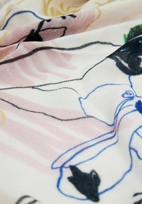 Leichtes Gewebe mit abstrakten Blumen- und Tierdesigns in Schwarz, Pink, Gelb und Blau, mit einer glatten, strukturierten Oberfläche.