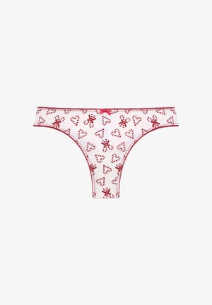 Weißer Tanga mit rotem Zuckerstangen- und Herzmuster, elastischem Bund und dekorativem pinken Bogen vorne. Mit roter Naht verziert.