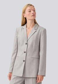 Gray pinstripe blazer with a tailored fit, single-breasted design, notch lapels, and two front pockets; buttons in dark brown.