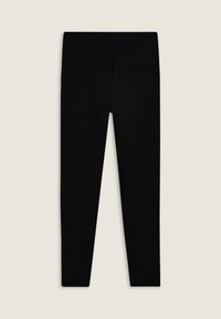 Leggings neri con una texture liscia e elastica, dotati di una vita alta e dettagli di cucitura sul retro. Taglio dritto.