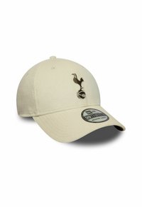 Cremfarbener Cord-Hut mit schwarzem Vogel-Logo, das auf einem Fußball steht, mit der Aufschrift Größe mittel-groß auf dem Schirm.