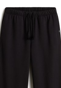Black sweatpants with elastic waistband and drawstring. Features side pockets and soft, textured fabric for comfort.