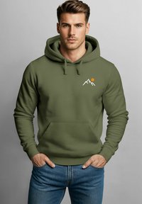Olive green hoodie made of soft fabric with a kangaroo pocket, featuring mountain and sun graphic in white and orange. Adjustable drawstring.