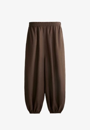 Pantaloni marroni larghi con vita elastica e polsini elasticizzati, realizzati in tessuto leggero.
