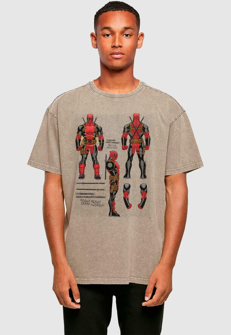 Gray oversized t-shirt with graphic print of a character in red and black, featuring detailed illustrations and text. Cotton material, casual design.