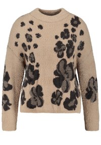 Pull beige avec des motifs floraux noirs. Tissu doux et texturé avec des manches longues et un col rond, présentant une coupe décontractée.