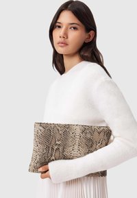 Schlangenledermuster-Clutch in Beige und Braun, rechteckige Form mit strukturiertem Oberfläche, gehalten gegen einen weißen Pullover.