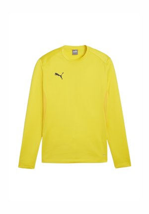 Gelbes, langärmliges Sportshirt aus glattem, leichtem Stoff. Verfügt über ein schwarzes Puma-Logo auf der linken Brust und einen Rundhalsausschnitt.
