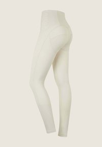 Leggings color crema a vita alta con una vita testurizzata, tessuto liscio, forma aderente al corpo e un design delle cuciture che accentua la vestibilità.