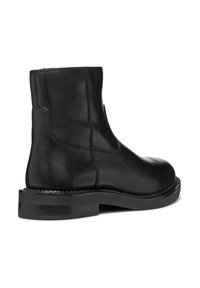 Black leather ankle boot with a smooth texture, rounded toe, and stitching details along the seams. Low, flat rubber sole.