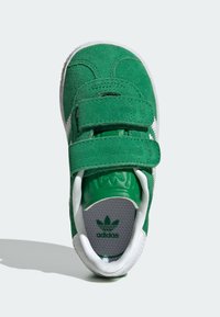 Green suede toddler sneaker with two Velcro straps, white sole, padded collar, and Adidas logo on the insole and tongue.