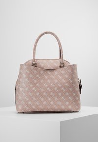 Jasnoróżowa torebka z powtarzającym się białym wzorem logo, podwójnymi uchwytami u góry, zapięciem na zamek i teksturowaną powierzchnią, stojąca na białym podeście.