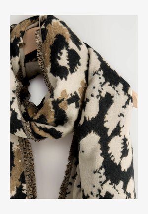 Vilnos mišinio šalikas su kreminiu pagrindu ir juodais bei ruda abstrakčiais raštais. Kraštai turi šiurkščią tekstūrą ir yra minkšti bei šilti.