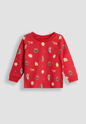 Czerwona koszula z długim rękawem z wzorem świątecznym przedstawiającym gwiazdy, skarpetki, wianki i trąbki. Wykonana z miękkiego, elastycznego materiału.