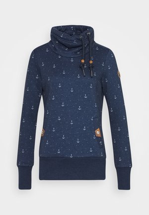 Granatowa bluza z białym wzorem kotwicy, z wysokim kołnierzem i regulowanymi sznureczkami, długimi rękawami oraz ściągaczami na mankietach i u dołu.