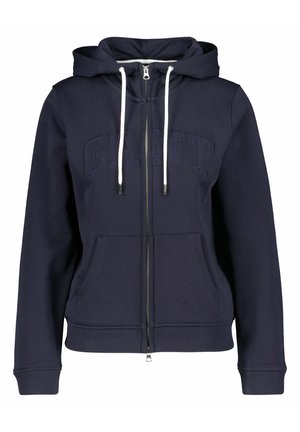 Granatowa bluza z kapturem na zamek błyskawiczny, z białymi sznurkami, przednimi kieszeniami, ściągaczami przy mankietach oraz wytłoczonym logo "GANT" na piersi.