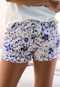 Floral-print shorts featuring a blend of purple, blue, and green on a light background. Elastic waistband with a drawstring detail.