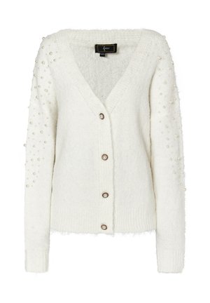 Valkoinen neuletakki, joka on valmistettu pörröisestä kankaasta. Siinä on V-pääntie, viisi nappia ja helmiakcentteja hihoissa. Rakenteellinen, pehmeä ja istuva.