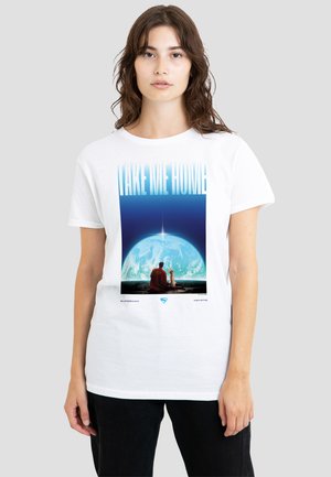 Young woman wearing white T-shirt with a graphic of Superman and dog sitting on a hill looking at Earth and text reading "Take Me Home."