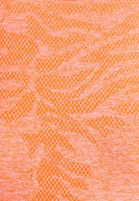 Orange and pink woven fabric with a textured geometric pattern of small squares and diagonal shapes.