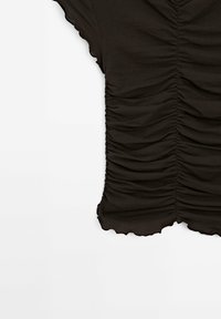 Black, short-sleeve top made of soft fabric featuring gathered texture along the front and a scalloped hemline.