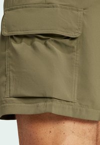 Knee-length khaki cargo shorts made of lightweight fabric, featuring a large side pocket with a flap and a smooth texture.