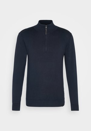 Pull bleu marine à manches longues avec col montant et zip quart. Fabriqué en matériau tricot doux avec une texture côtelée aux poignets et à l'ourlet.