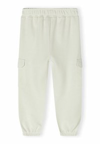 Helle beigem Sweatpants mit einem elastischen Bund, schmal zulaufenden Bündchen und zwei seitlichen Cargo-Taschen für zusätzlichen Stauraum. Weicher, strukturierter Stoff.