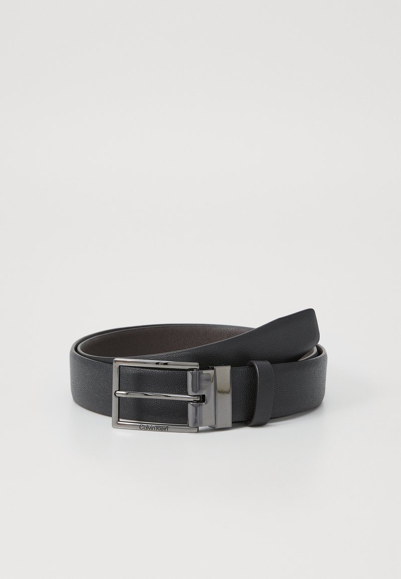 Black leather belt with a smooth texture, featuring a silver metal buckle and a prong closure. The inner side is dark brown.