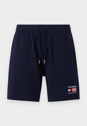 Donkerblauwe zwembroek met een elastische tailleband, trekkoord en een klein geborduurd logo op de linkeronderkant. Gladde stofstructuur.