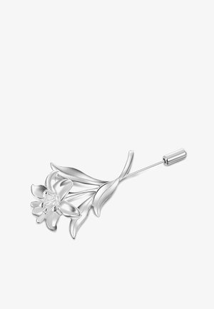 Srebrna broszka w kształcie lilii, z misternie wykonanymi płatkami i liśćmi. Projekt zawiera długi szpikulec do przypinania oraz gładką fakturę.