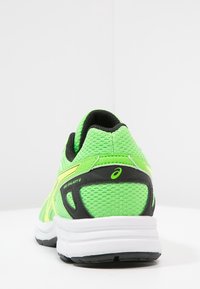 Zielony but sportowy z siateczkową cholewką, czarnymi akcentami i białą podeszwą. Posiada zaokrąglony obcas oraz żywą żółtą grafikę logo po boku.