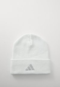 White knitted beanie with a folded brim, featuring a light gray Adidas logo stitched on the front. Smooth texture, rounded top.