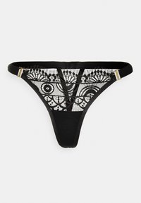 Tanga preta com painel de renda apresentando padrões circulares e detalhes delicados. Alças finas e acabamentos em tom dourado. Textura de tecido suave.