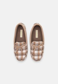 Brown and beige plaid moccasin slippers with a soft fabric upper, bow detail, and textured soles for traction. Rounded toe design.