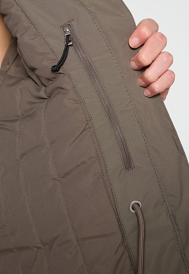 Braune gesteppte Jacke aus leichtem Stoff, mit versteckter Reißverschlusstasche und verstellbarem Zugbandsaum. Strukturierte, glatte Oberfläche.