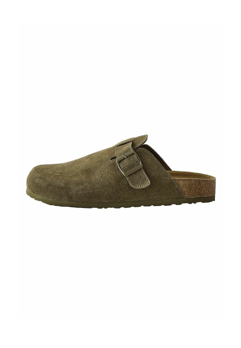 Olive green suede slip-on shoe with a metal buckle detail, rounded toe, textured upper, and a brown cork footbed. Flat rubber sole.
