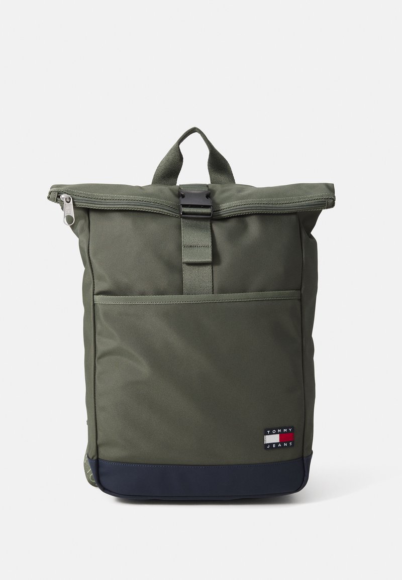 Green roll-top backpack with a black zipper, textile material, rectangular shape, and a front pocket. Features a Tommy Jeans logo patch.