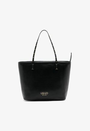 Mustast nahast käekott kahe õlarihmaga, millel on kuldsed detailid ja brändilogoga põhjas. Sile pind ja hästi vormitud kuju.