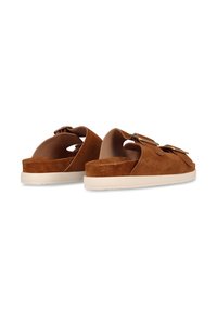 Brown suede slide sandals with a thick white sole, featuring two decorative buckles on the upper strap and an open back design.