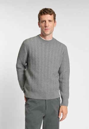 Gray knit sweater with a herringbone pattern, crew neckline, and ribbed cuffs. Paired with gray pants for a monochromatic look.