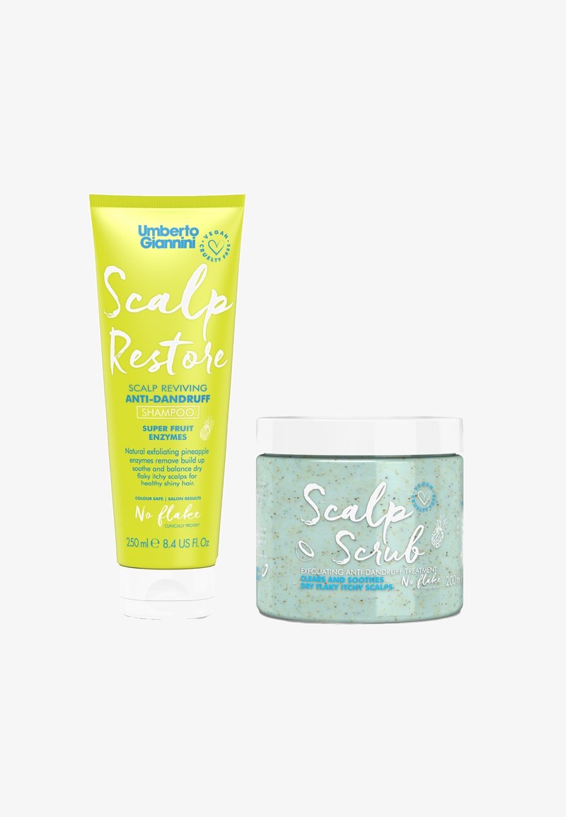 Geel tubetje met groene en blauwe tekst, gelabeld "Scalp Restore," en een blauwe pot met spikkels, gelabeld "Scalp Scrub." Beide zijn haarverzorgingsproducten.