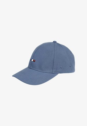 Blue cotton baseball cap with a textured surface, curved brim, and small embroidered red, white, and blue stripe detail on the front.