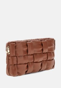 Barna bőr clutch táska szőtt textúrával és arany színű kiegészítőkkel. Jellemzője a téglalap alak és a párnázott megjelenés.