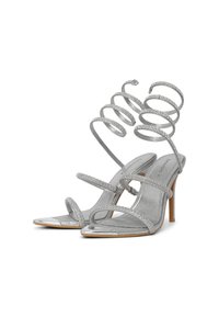 Silver high-heeled sandals with multiple thin straps and a spiraled ankle strap. Glossy finish with metallic accents on the toe area.