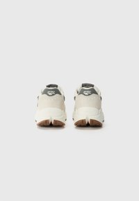 Footwear with a light gray mesh upper, padded collar, black branding on heel, and a textured rubber outsole. Features a cushioned sole.