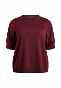 Bordeauxrotes kurzärmeliges Strickoberteil mit rundem Ausschnitt und gerippten Bündchen. Weiche Textur und lockere Passform mit dezenten Nahtdetails.